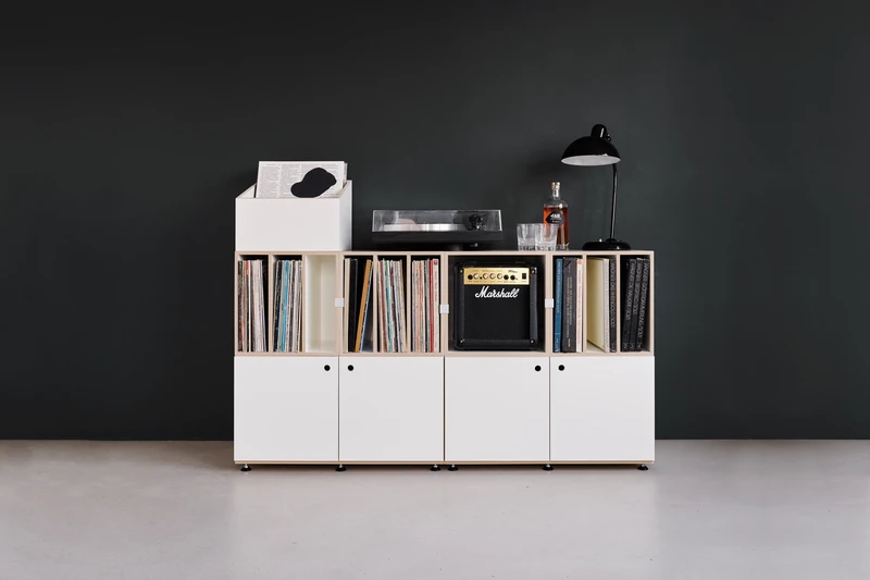 A single tall stocubo shelving column against a wall, filled with records and books